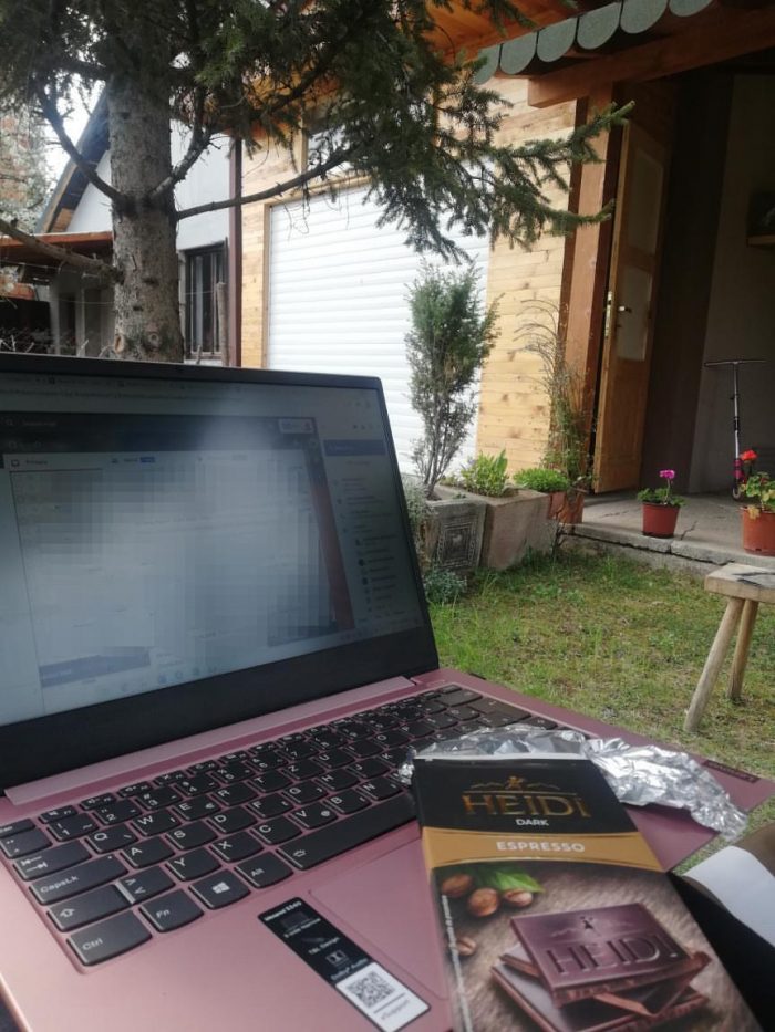 A home office desk setup for remote work, set in the backyard.