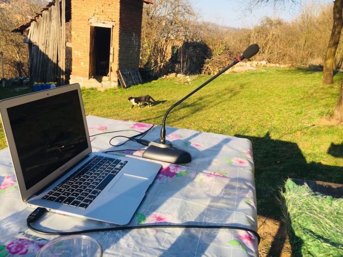 A home office desk setup for remote work, set in the backyard.
