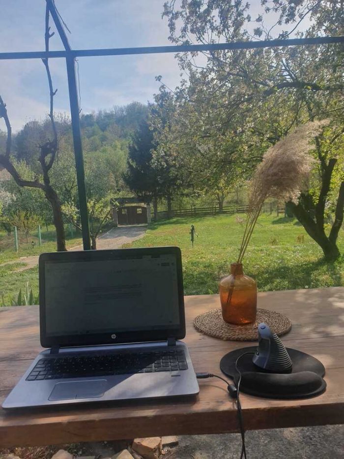 A home office desk setup for remote work, set in the backyard.