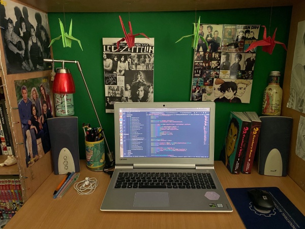 A home office desk setup for remote work, decorated with origami birds.