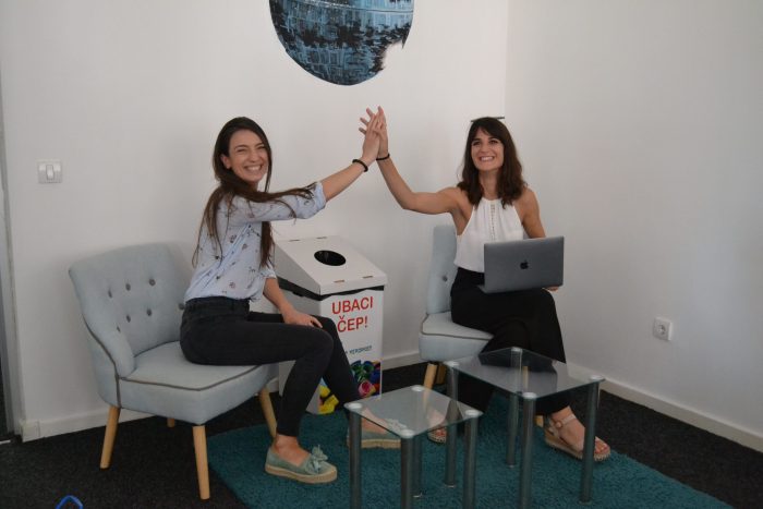 Two women are giving each other a high five.